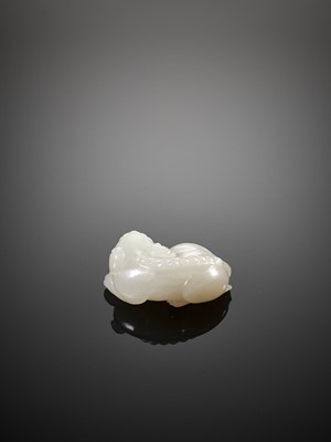 Lot 454 - A WHITE JADE FIGURE OF A BUDDHIST LION, QING DYNASTY