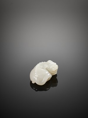 Lot 454 - A WHITE JADE FIGURE OF A BUDDHIST LION, QING DYNASTY