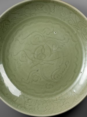 Lot 479 - A MASSIVE CARVED ‘LOTUS’ LONGQUAN CELADON CHARGER, EARLY MING DYNASTY