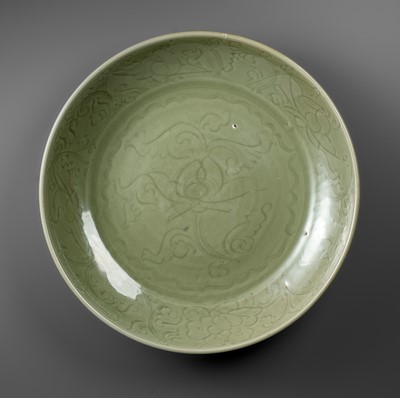 Lot 479 - A MASSIVE CARVED ‘LOTUS’ LONGQUAN CELADON CHARGER, EARLY MING DYNASTY