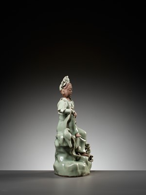 Lot 482 - A LONGQUAN CELADON AND BISCUIT FIGURE OF GUANYIN, MING DYNASTY