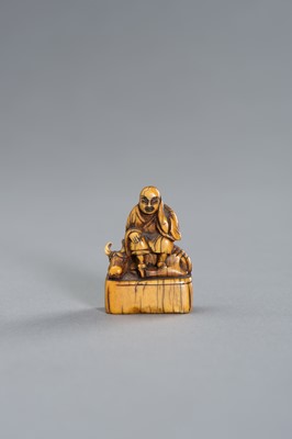 Lot 416 - AN EARLY IVORY NETSUKE OF ROSHI AND OX