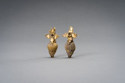 Lot 1311 - A PAIR OF INDIAN GOLD ORNAMENTS WITH CONCH AND FLOWER