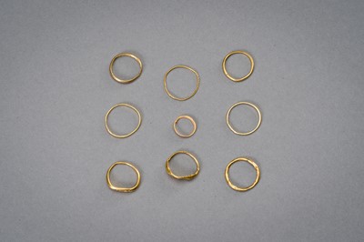 Lot 1220 - A COLLECTION OF NINE PYU GOLD RINGS