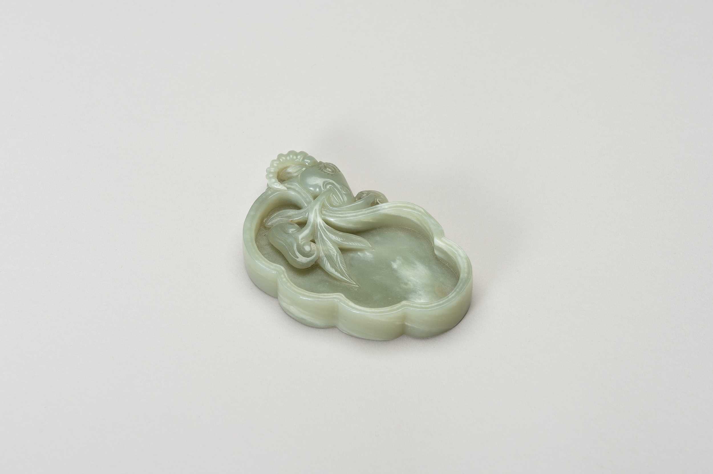 Lot 249 - A CARVED CELADON JADE LINGZHI-FORM BRUSH WASHER WITH A RAM