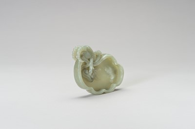 Lot 249 - A CARVED CELADON JADE LINGZHI-FORM BRUSH WASHER WITH A RAM