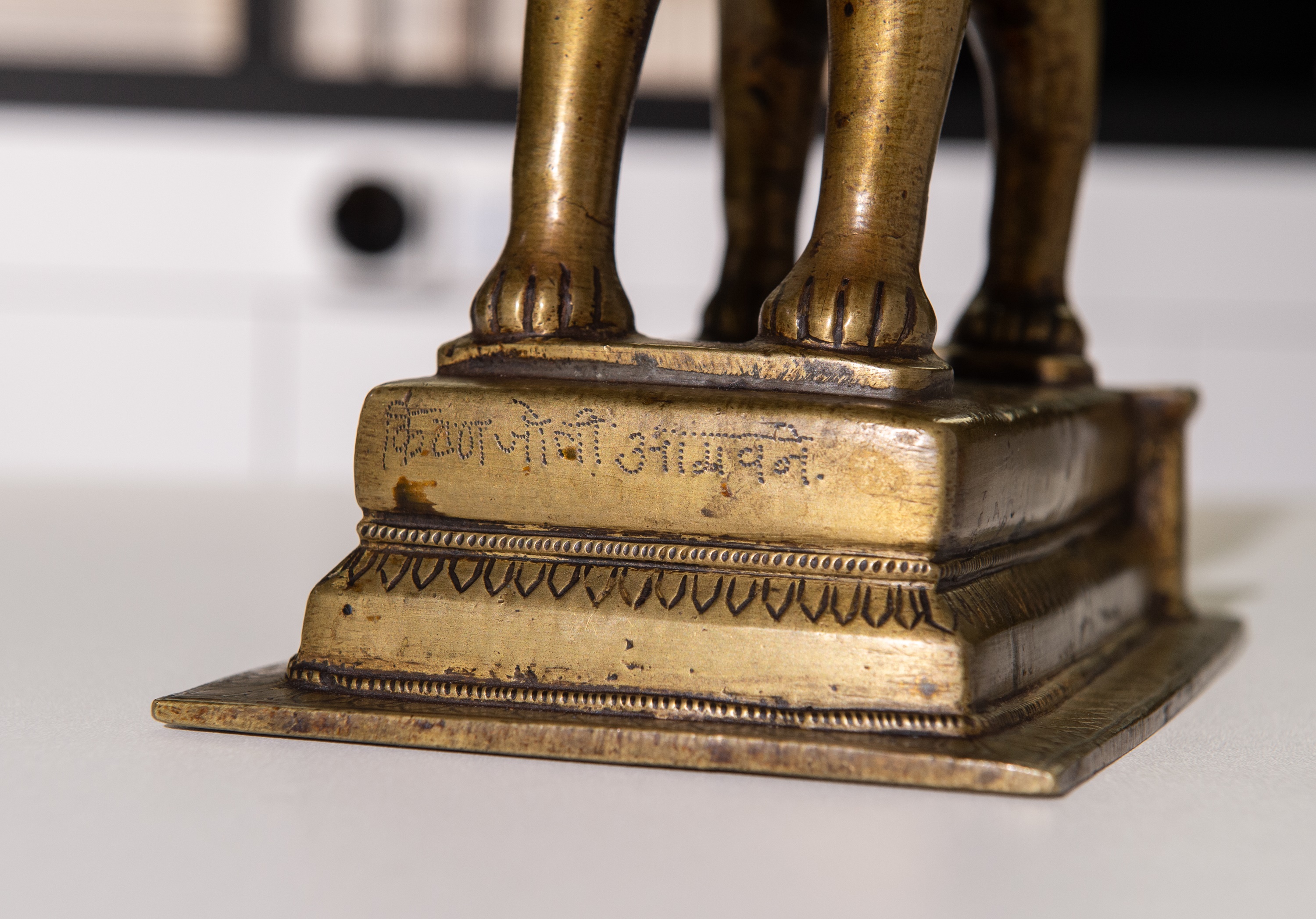 Lot 702 - A BRONZE FIGURE OF DURGA RIDING A LION,