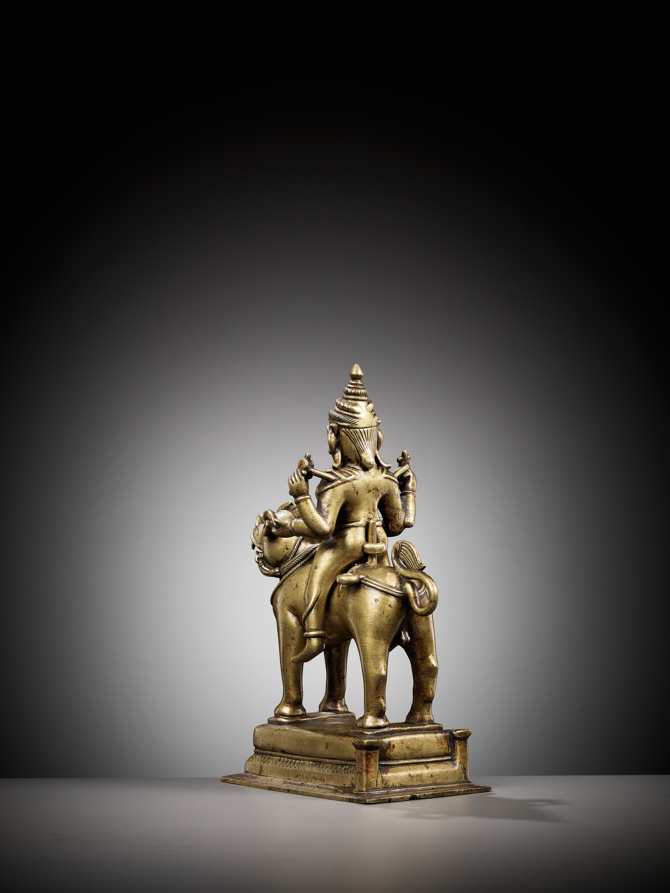 Lot 702 - A BRONZE FIGURE OF DURGA RIDING A LION,