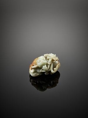 Lot 101 - A CELADON AND RUSSET JADE BUDDHIST LION, LATE MING TO EARLY QING DYNASTY