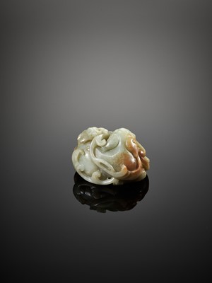 Lot 101 - A CELADON AND RUSSET JADE BUDDHIST LION, LATE MING TO EARLY QING DYNASTY