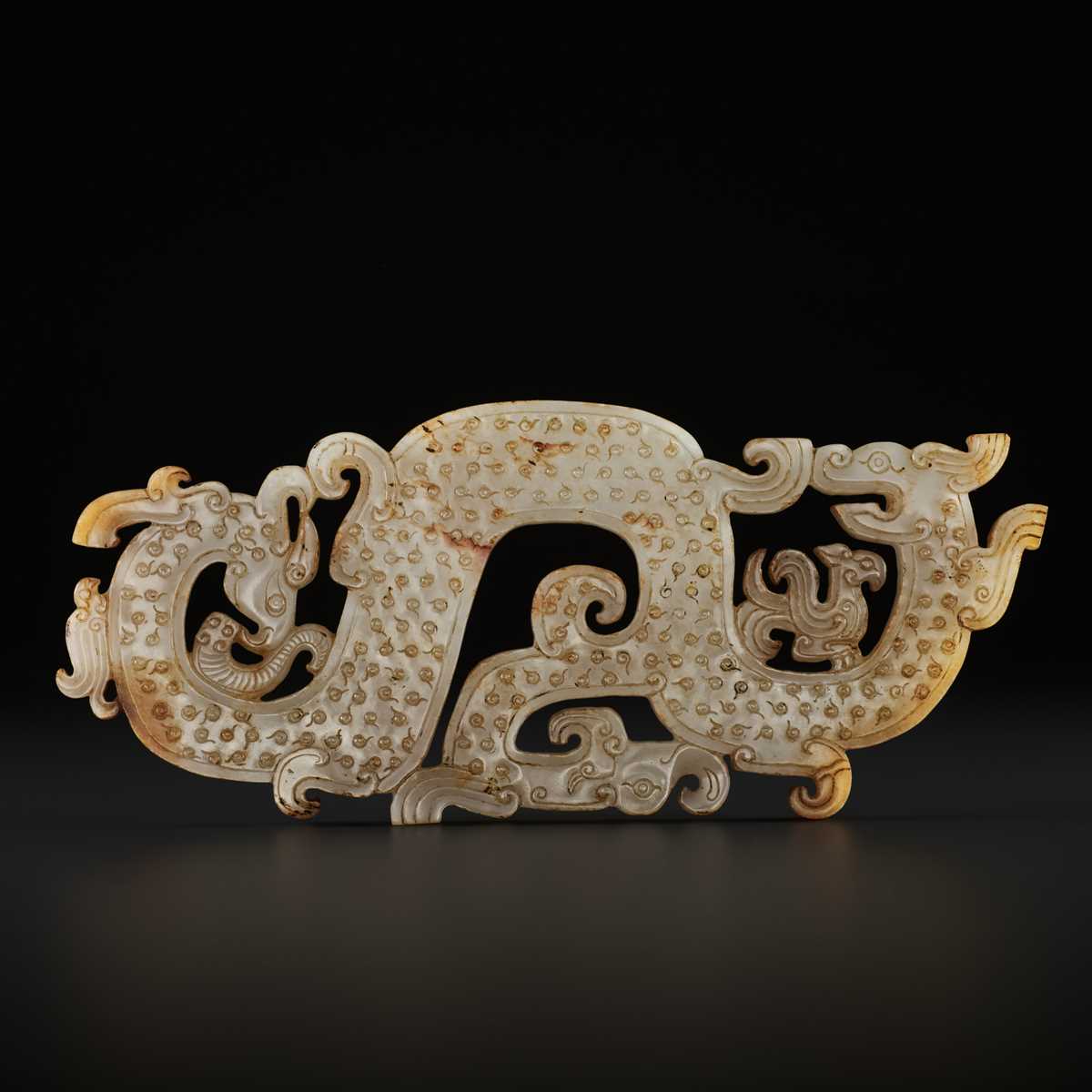 Lot 71 - A LARGE AND IMPORTANT WHITE JADE ‘DRAGON AND PHOENIX’ PENDANT, WARRING STATES
